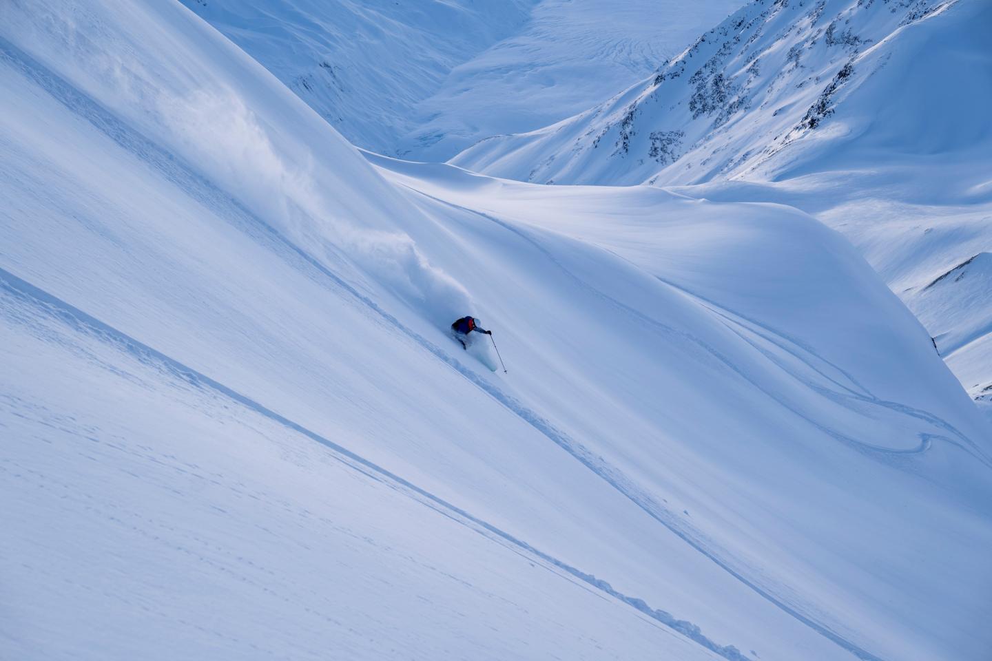 Chris skiing on fresh powder on a sunny day