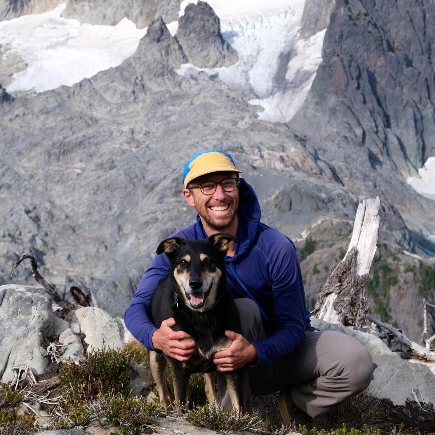 A portrait of Cam Deamer-Phillips with his dog