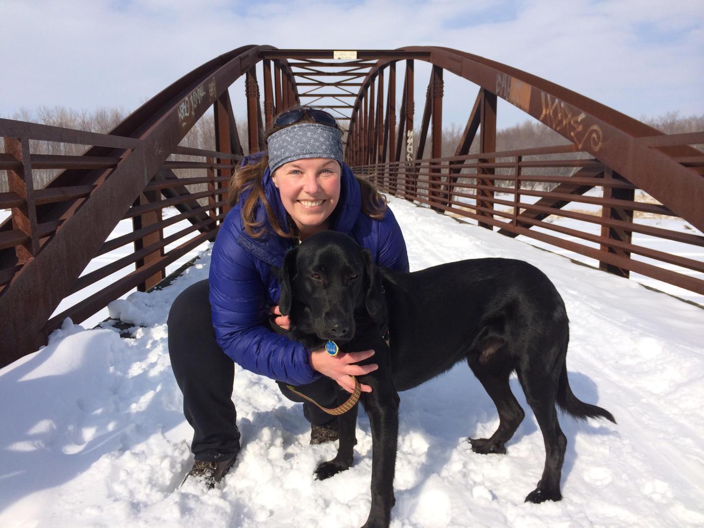 Hannah Loope in the snow with her dog